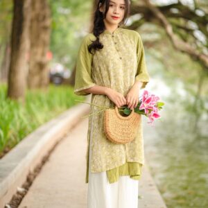 a woman standing on a sidewalk holding a basket of flowers