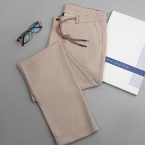 a pair of glasses, a book, and a pair of pants on a table